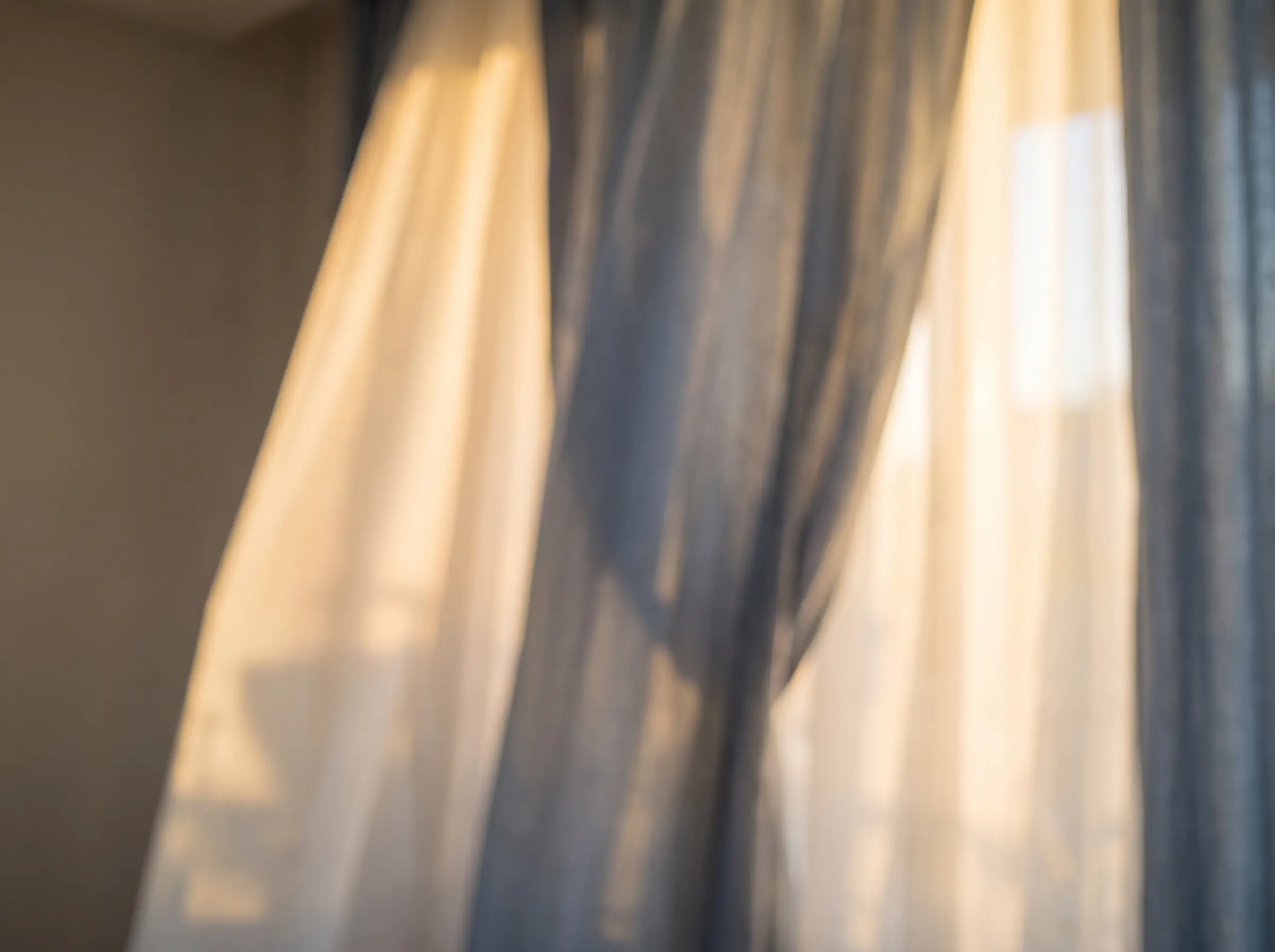Evening light through sheer curtains in a quiet room